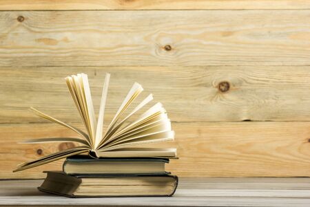 Open book, hardback books on wooden table. Back to school. Copy space.の写真素材