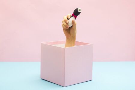 Woman holding Sex toy for adult. Gift box, special offer and sale time concept.の写真素材