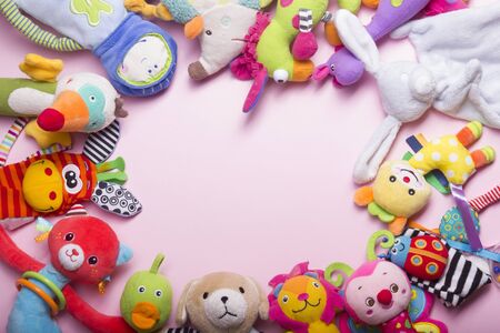 Colorful kids toys frame on wooden background. Top view. Flat lay. Copy space for text.の写真素材