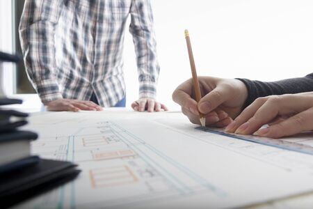 Architects working on blueprint. Architects workplace - architectural project, blueprints, ruler, calculator, laptop and divider compass. Construction concept. Engineering tools.の写真素材