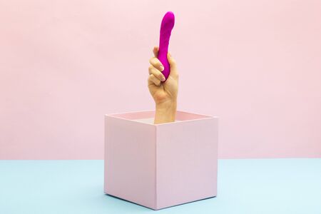 Woman holding Sex toy for adult. Gift box, special offer and sale time conceptの写真素材