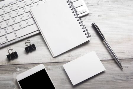 White desk office with laptop, smartphone and other work supplies with cup of coffee. Top view with copy space for input the text. Designer workspace on desk table essential elements on flat lay.の写真素材