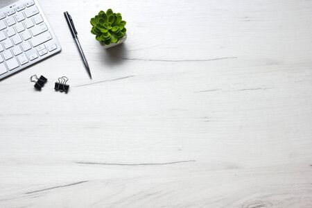 White desk office with laptop, smartphone and other work supplies with cup of coffee. Top view with...