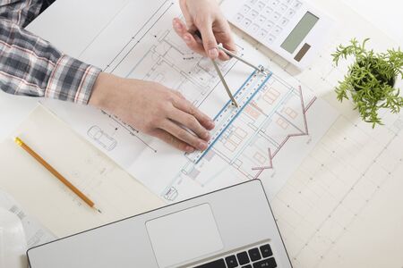 Architects working on blueprint, real estate project. Architect workplace. Construction concept. Engineering tools.の写真素材
