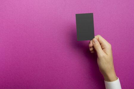 Hand holding white business card on abstract backgroundの写真素材
