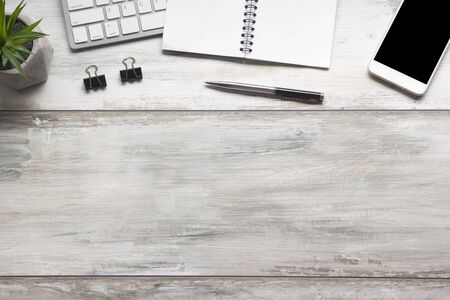 White desk office with laptop, smartphone and other work supplies with cup of coffee. Top view with copy space for input the text. Designer workspace on desk table essential elements on flat lay.の写真素材