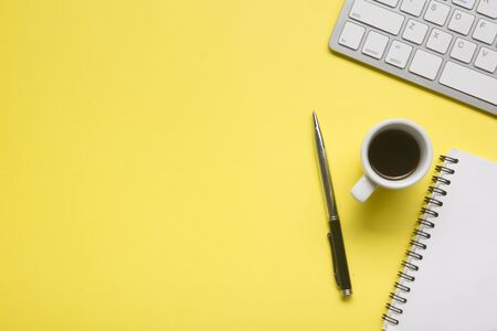 Yellow desk office with laptop, smartphone and other work supplies with cup of coffee. Top view with copy space for input the text. Designer workspace on desk table essential elements on flat lay.の写真素材