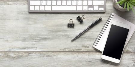 White desk office with laptop, smartphone and other work supplies with cup of coffee. Top view with copy space for input the text. Designer workspace on desk table essential elements on flat lay.の写真素材