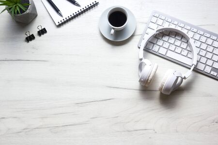 White desk office with laptop, smartphone and other work supplies with cup of coffee. Top view with copy space for input the text. Designer workspace on desk table essential elements on flat lay.の写真素材