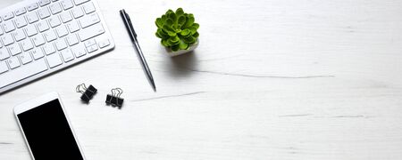 White desk office with laptop, smartphone and other work supplies with cup of coffee. Top view with copy space for input the text. Designer workspace on desk table essential elements on flat lay.の写真素材