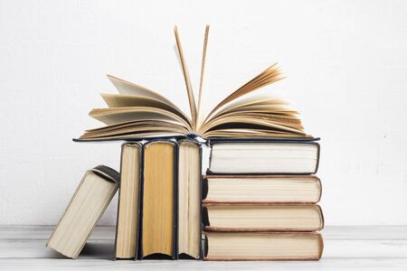 Open book, hardback books on wooden table. Back to school. Copy space.の写真素材