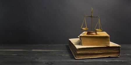 Law concept - Open law book with a wooden judges gavel on table in a courtroom or law enforcement office isolated on white background. Copy space for textの写真素材