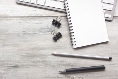 White desk office with laptop, smartphone and other work supplies with cup of coffee. Top view with copy space for input the text. Designer workspace on desk table essential elements on flat layの写真素材