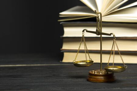 Law concept - Open law book with a wooden judges gavel on table in a courtroom or law enforcement office isolated on white background. Copy space for text.の写真素材