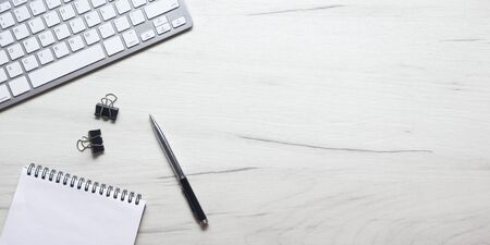 White desk office with laptop, smartphone and other work supplies with cup of coffee. Top view with copy space for input the text. Designer workspace on desk table essential elements on flat lay.の写真素材