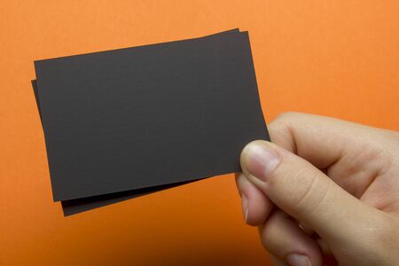 Hand holding business card blank on abstract backgroundの写真素材