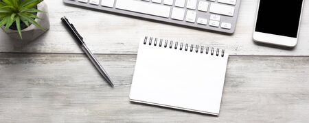 White desk office with laptop, smartphone and other work supplies with cup of coffee. Top view with copy space for input the text. Designer workspace on desk table essential elements on flat layの写真素材
