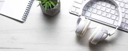 White desk office with laptop, smartphone and other work supplies with cup of coffee. Top view with...