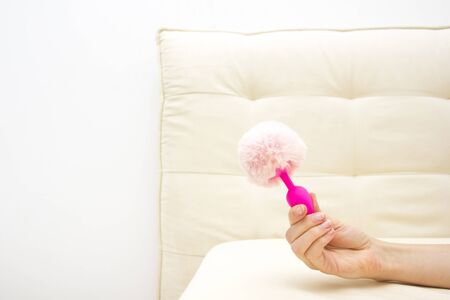 Female in bad holding a vibrator. Sex toy for adultの写真素材