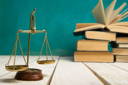 Law concept - Open law book with a wooden judges gavel on table in a courtroom or law enforcement office isolated on white background. Copy space for textの写真素材