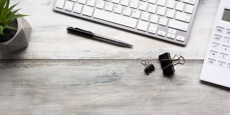 White desk office with laptop, smartphone and other work supplies with cup of coffee. Top view with...