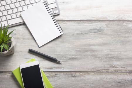 White desk office with laptop, smartphone and other work supplies with cup of coffee. Top view with copy space for input the text. Designer workspace on desk table essential elements on flat lay.の写真素材