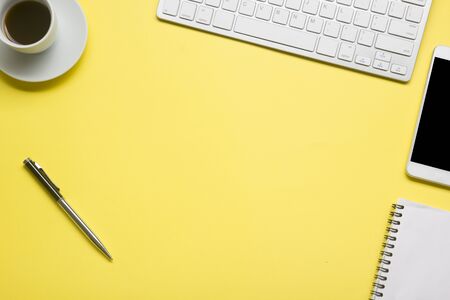 White desk office with laptop, smartphone and other work supplies with cup of coffee. Top view with copy space for input the text. Designer workspace on desk table essential elements on flat layの写真素材