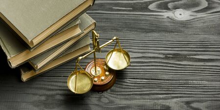 Law concept - Open law book with a wooden judges gavel on table in a courtroom or law enforcement...