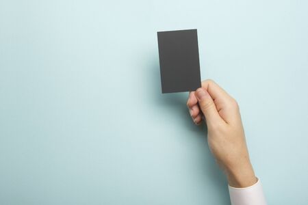 Hand holding business card blank on abstract backgroundの写真素材