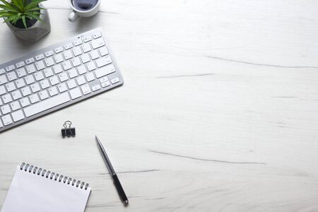 White desk office with laptop, smartphone and other work supplies with cup of coffee. Top view with copy space for input the text. Designer workspace on desk table essential elements on flat lay.の写真素材