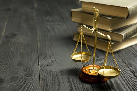 Law concept - Open law book with a wooden judges gavel on table in a courtroom or law enforcement office isolated on white background. Copy space for text.の写真素材