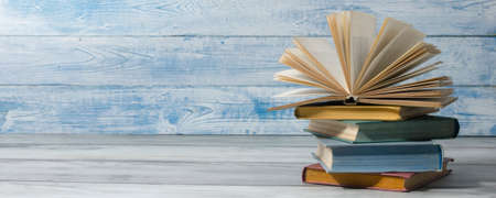 Open book, hardback books on wooden table. Back to school. Copy spaceの写真素材
