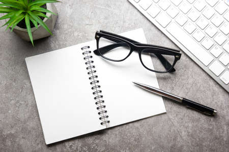 White desk office with laptop, smartphone and other work supplies with cup of coffee. Top view with copy space for input the text. Designer workspace on desk table essential elements on flat layの写真素材