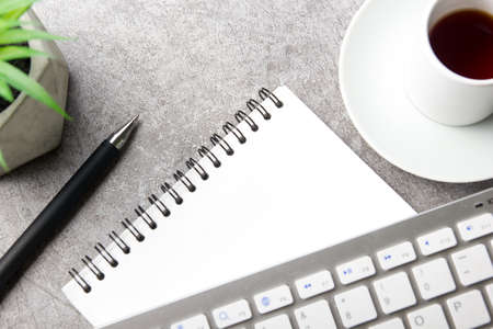 White desk office with laptop, smartphone and other work supplies with cup of coffee. Top view with copy space for input the text. Designer workspace on desk table essential elements on flat layの写真素材