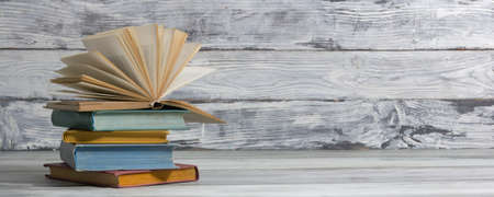 Open book, hardback books on wooden table. Back to school. Copy spaceの写真素材