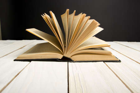 Open book, hardback books on wooden table. Back to school. Copy spaceの写真素材