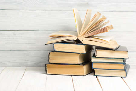 Open book, hardback books on wooden table. Back to school. Copy space