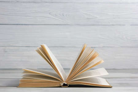 Open book, hardback books on wooden table. Back to school. Copy space