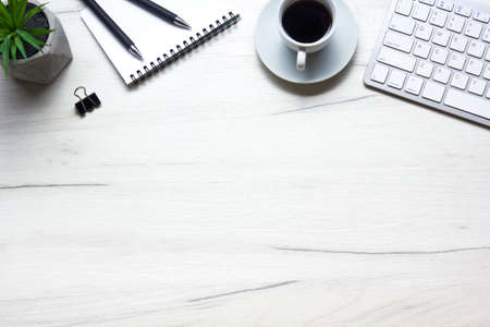 White desk office with laptop, smartphone and other work supplies with cup of coffee. Top view with copy space for input the text. Designer workspace on desk table essential elements on flat layの写真素材