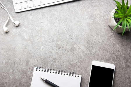 White desk office with laptop, smartphone and other work supplies with cup of coffee. Top view with copy space for input the text. Designer workspace on desk table essential elements on flat layの写真素材