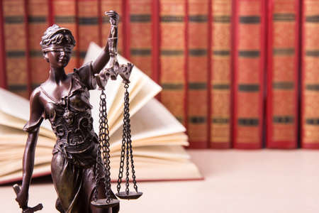 Law concept - Wooden judges gavel and book on table in a courtroom or law enforcement office. Copy...