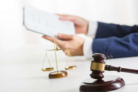 Lawyer working with contract papers and wooden gavel on tabel in courtroom. justice and law ,attorney, court judge concept.の写真素材