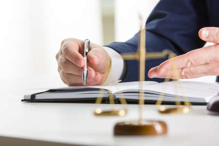 Lawyer working with contract papers and wooden gavel on tabel in courtroom. justice and law ,attorney, court judge concept.の写真素材
