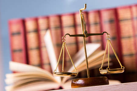 Law concept - Open law book with a wooden judges gavel on table in a courtroom or law enforcement office isolated on white background. Copy space for text.の写真素材