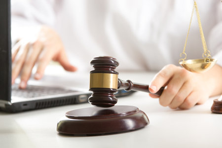 Lawyer working with contract papers and wooden gavel on tabel in courtroom. justice and law ,attorney, court judge concept.の写真素材