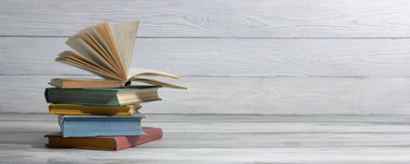 Open book, hardback books on wooden table. Back to school. Copy space.の写真素材