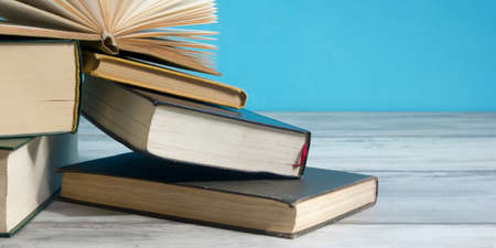 Open book, hardback books on wooden table. Back to school. Copy space.の写真素材