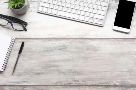 White desk office with laptop, smartphone and other work supplies with cup of coffee. Top view with copy space for input the text. Designer workspace on desk table essential elements on flat lay.の写真素材