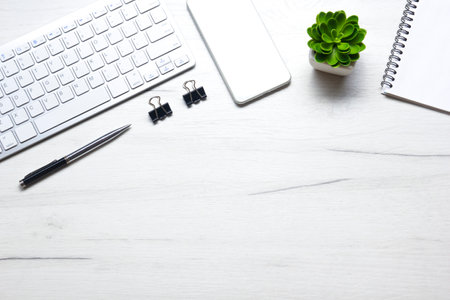 White desk office with laptop, smartphone and other work supplies with cup of coffee. Top view with copy space for input the text. Designer workspace on desk table essential elements on flat lay.の写真素材