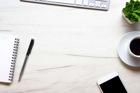 White desk office with laptop, smartphone and other work supplies with cup of coffee. Top view with copy space for input the text. Designer workspace on desk table essential elements on flat lay.の写真素材